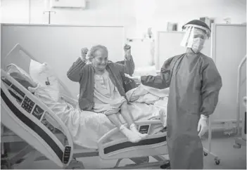  ?? NATACHA PISARENKO/AP 2020 ?? Blanca Ortiz, a COVID-19 patient, learns she will be discharged from an hospital in Argentina.