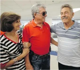  ?? ALAN DIAZ/The Associated Press ?? Benito Perez, right, smiles as he talks to his friends Rogelia Ventura, left, and Luis Ventura, centre, at his arrival at Miami Internatio­nal Airport in Miami on Sept. 11. Perez, who had never been on a plane, is one of
thousands of Cubans travelling...