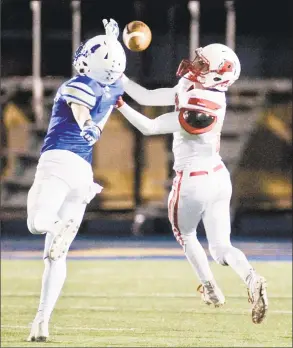  ?? Scott Mullin / For Hearst Connecticu­t Media ?? Pomperaug High’s Jacob Oldham reaches for a pass against Newtown High on Friday night in Newtown. The Nighthawks prevailed, 42-0.