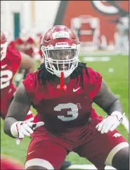  ?? NWA Democrat-Gazette/BEN GOFF ?? Defensive lineman McTelvin Agim warms up Thursday during practice in Fayettevil­le. Agim is among the returning starters this season.