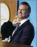  ?? STEPHEN LAM/GETTY IMAGES ?? Governor Gavin Newsom carries his 2year-old son Dutch while delivering his inaugural address after being sworn in as the 40th governor of California on Jan. 7 in Sacramento.
