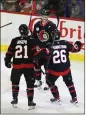  ?? PATRICK DOYLE — THE CANADIAN PRESS VIA AP ?? Ottawa Senators defenseman Artem Zub (2) celebrates after his goal against the Detroit Red Wings with teammates Mathieu Joseph (21) and Erik Brannstrom (26) during first-period NHL hockey game action in Ottawa, Ontario, Sunday.