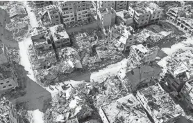  ?? AFP VIA GETTY IMAGES ?? An aerial view on Tuesday shows destroyed buildings in Beit Lahia following Israeli bombardmen­ts in the northern Gaza Strip.