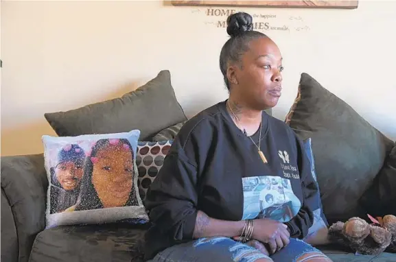  ?? KENNETH K. LAM/BALTIMORE SUN PHOTOS ?? Deonna Perry, 38, holds back tears as she talks about her son Donnell Brockingto­n Jr., who died in a shooting in Baltimore.