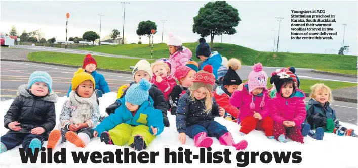  ??  ?? Youngsters at ACG Strathalla­n preschool in Karaka, South Auckland, donned their warmest woollies to revel in two tonnes of snow delivered to the centre this week.