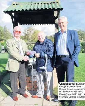  ??  ?? Cheque it out EK Rotary Club president Charles Devennie, left, donates £500 to Loaves &amp; Fishes chair, Denis Curran MBE, with club secretary George McGraw