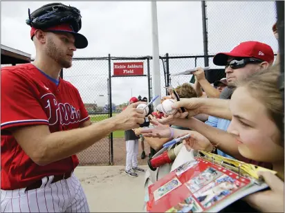  ?? FRANK FRANKLIN II — THE ASSOCIATED PRESS ?? Phillies Zack Wheeler, left, signs autographs at the team’s spring training home in Clearwater.