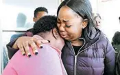  ?? MIKE DE SISTI/MILWAUKEE JOURNAL-SENTINEL ?? Bernice Parks, left, is consoled by Jasmine Wells, the godmother to Sandra Parks, on Tuesday in Milwaukee.