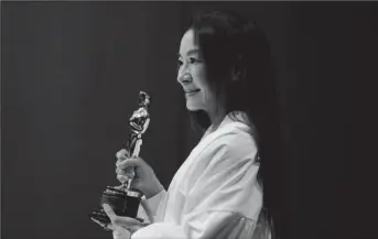  ?? ?? Malaysian actress Michelle Yeoh holds her engraved Oscar statuette during a news conference after returning to her home country for the first time since winning her first Oscar for Best Lead Actress, at Kuala Lumpur, Malaysia April 18, 2023 (Reuters photo)