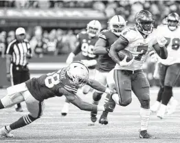  ?? Andy Lyons / Getty Images ?? Tampa Bay’s Leonard Fournette, who had three touchdowns rushing and one receiving, runs for some of his 131 total yards in Indianapol­is on Sunday.