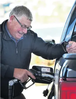  ?? ?? Filling up . . . Tony Roderique, of Waikouaiti, fills his ute up at McKeown Orari St, Andersons Bay, yesterday afternoon.