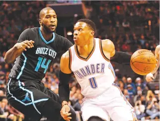  ??  ?? OKLAHOMA CITY THUNDER guard Russell Westbrook (0) drives to the basket as he is defended by Charlotte Hornets forward Michael Kidd-Gilchrist (14) during the first half at the Spectrum Center.