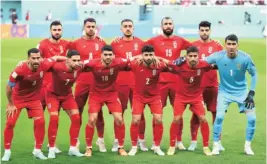  ?? ?? Iranian players pose before the start of their match against England. They lost 4-1, but the team’s refusal to sing the anthem was widely seen as supporting the anti-government protests in Iran