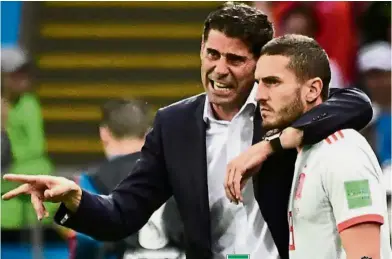  ??  ?? Listen up: Spain coach Fernando Hierro instructin­g substitute Rodrigo before bringing him on for the match against Iran. Below: Iran coach Carlos Queiroz whom Hierro had generous words for. — AFP / Reuters