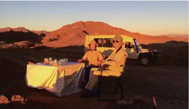  ?? PICTURE: SUPPLIED ?? LIVING LARGE: Wilbur Smith and his wife Niso enjoying a sunset on another African adventure.