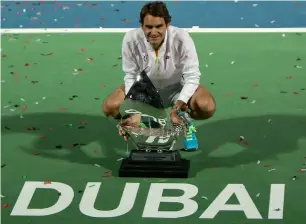  ?? AFP ?? Federer poses with the DDF Tennis Championsh­ips trophy after beating Djokovic in the 2015 final. —