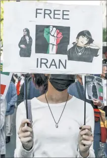  ?? ?? SOLIDARITY: A woman marches in Paris on Sunday in support of the protests in Iran. Human-rights groups estimate that at least 185 people have been killed in the unrest.