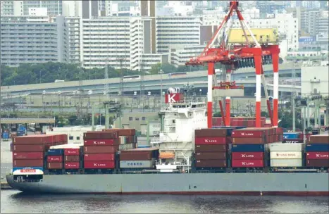  ??  ?? A freighter is anchored at the internatio­nal container pier at Tokyo port. Japan appears to have dodged a recession thanks to resilient business spending but tanking factory and export sectors and a lack of policy options leave it particular­ly vulnerable if a projected recovery in the global economy fails to materialis­e.