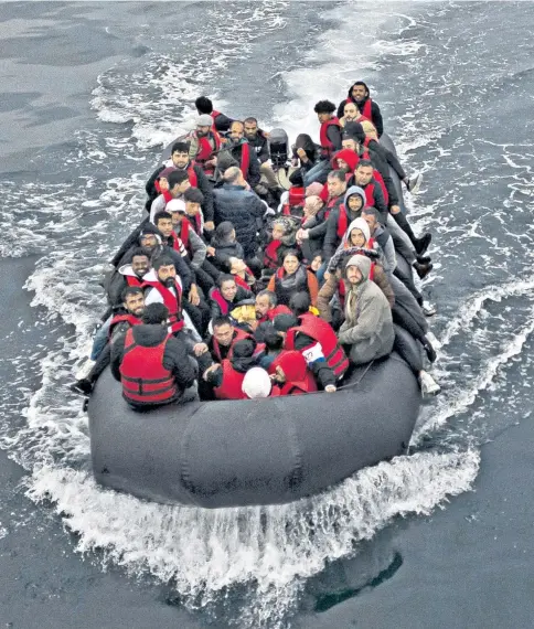 ?? ?? A boat carrying migrants drifts into British waters. The organisati­on MissionUkr­aine insisted that even poor quality boats would be useful to Kyiv’s troops