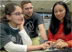  ?? WARWICK SMITH/ STUFF ?? Palmerston North Girls’ High School students Reem Al-rimal Al-shammari, left, and Minh Dao, right, work with Hamish Simmonds in an engineerin­g workshop.