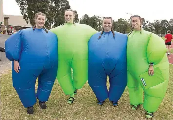  ?? ?? Flynn Burgess-Pincini, Mackenzie Heywood, school captain Sydney Blackshaw and Drake house captain Portia Bell dressed in blue and green blow up suits.