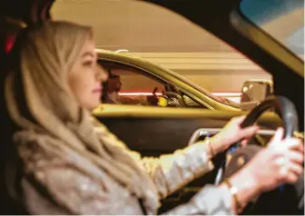  ?? Gehad Hamdy / Tribune News Service ?? Walaa Abou Najem drives her car for the first time in Riyadh, Saudi Arabia. The kingdom has ended a bevy of restrictio­ns on women in the biggest weakening of the “guardiansh­ip” system.