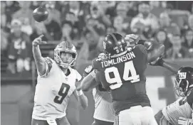  ?? ROBERT DEUTSCH/USA TODAY SPORTS ?? Lions quarterbac­k Matthew Stafford, top left, throws a pass against the Giants in the first half Monday at MetLife Stadium in East Rutherford, N.J.