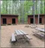  ??  ?? Bunkhouse-style lean-tos are set amidst a stand of tall pines at Camp Boyhaven.