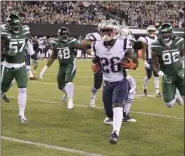  ?? BILL KOSTROUN - THE ASSOCIATED PRESS ?? New England Patriots running back Sony Michel (26) gets away from New York Jets’ C.J. Mosley (57) and Leonard Williams (92) for a touchdown during the first half of a game Monday, Oct. 21, 2019, in East Rutherford, N.J.