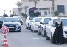  ?? — AFP ?? Vehicles wait to cross at the recently reopened Nassib border post in the Deraa province, at the Syrian-jordanian border south of Damascus on Sunday.