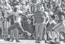  ?? AP PHOTO/BUTCH DILL ?? The Citadel running back Dante Smith heads to the end zone as Alabama linebacker Mack Wilson pursues in the first half of Saturday’s game in Tuscaloosa. Alabama won 50-17, but the game was tied at 10 at halftime.