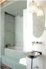  ??  ?? This spa bath was designed to fit into a small space with contempora­ry style, and without giving up a tub.