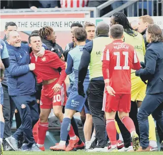  ??  ?? George Honeyman is held back in the late melee on Saturday.