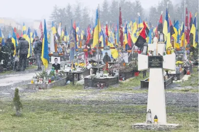  ?? Picture: AFP ?? SILENT WITNESSES. Graves of Ukrainian soldiers line Lychakiv cemetery in the western Ukrainian city of Lviv. Commanders say Kyiv’s troops are being outgunned by Russia along the front line.