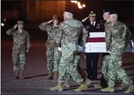  ?? AP/CLIFF OWEN ?? An Army carry team moves the remains of Spc. Ryan Dennis Orin Riley of Richmond, Ky., to a waiting vehicle at Delaware’s Dover Air Force Base on Tuesday, three days after Riley died in Iraq from a noncombat-related incident.