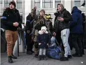  ?? Tyler Hicks / New York Times ?? Ukrainian security forces stand guard Tuesday as people board an evacuation train in Odesa, Ukraine. More than 3 million have fled the country.