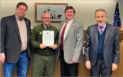  ?? CHAD FELTON — THE NEWS-HERALD ?? Lake County Commission­ers John Plecnik, John Hamercheck and Ron Young stand with James A. Garfield National Historic Site Manager Todd Arrington, second from left, in chambers during a recent proclamati­on honoring the 20th president.