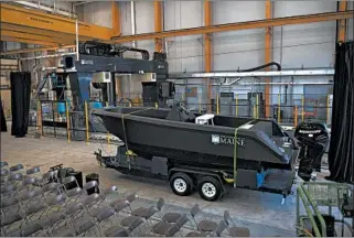  ?? RON LISNET/UNIVERSITY OF MAINE ?? A polymer 3D printer created the 25-foot, 5,000-pound boat, which was unveiled in Orono, Maine.