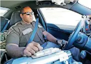  ?? [PHOTO BY
STEVE GOOCH,
THE OKLAHOMAN] ?? Trooper Chantz Jackson, with Oklahoma
Highway Patrol’s Troop A, drives his patrol car in
Oklahoma City.