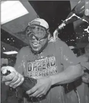  ?? Associated Press ?? Celebrate: Cleveland Indians' Edwin Encarnacio­n celebrates in the clubhouse after the Indians defeated the Detroit Tigers 15-0 to clinch the American League Central Division, in a baseball game, Saturday.