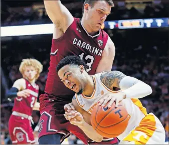  ?? [WADE PAYNE/THE ASSOCIATED PRESS] ?? Tennessee’s Lamonte Turner drives against South Carolina’s Felipe Haase in the second half of the Vols’ 85-73 win.