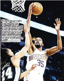  ?? AFP PHOTO ?? Kevin Durant (right) of the Phoenix Suns drives over Devin Vassell of the San Antonio Spurs in the first half at Frost Bank Center on March 23, 2024, in San Antonio, Texas.