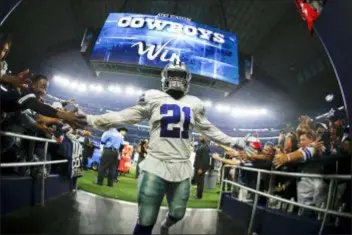  ?? RON JENKINS — THE ASSOCIATED PRESS ?? Cowboys running back Ezekiel Elliott greets fans as he comes off the field after the Cowboys win over Washington Thursday.