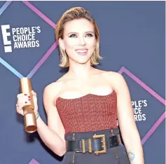 ??  ?? Scarlett Johansson poses with her award for The Female Movie Star of 2018 during the People’s Choice Awards 2018 at Barker Hangar, in Santa Monica, California, on Sunday.