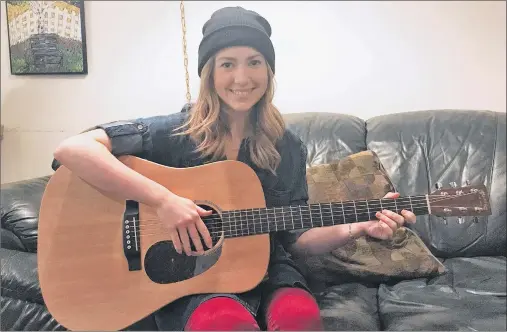  ?? KATIE SMITH/THE GUARDIAN ?? Musician Alicia Toner poses with her guitar in Charlottet­own on Jan. 23. Toner is nominated for five Music P.E.I. awards, including the award for new artist.