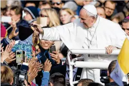  ?? ASSOCIATED PRESS ?? Pope Francis reaches out to a child as he arrives to celebrate a Mass in Freedom Square, in Tallinn, Estonia on Tuesday. Pope Francis concluded his four-day tour of the Baltics.