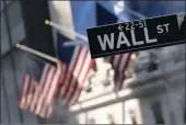  ?? MARK LENNIHAN — THE ASSOCIATED PRESS FILE ?? A sign for Wall Street hangs in front of the New York Stock Exchange.