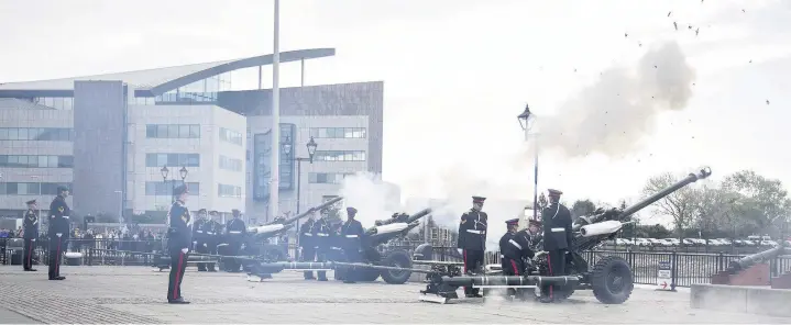  ??  ?? > Gunner James Robinson, of 104 Regiment Royal Artillery, at the gun salute for the Queen’s birthday in Cardiff Bay