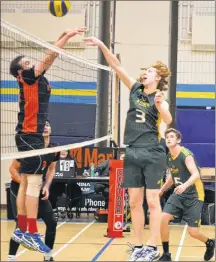  ?? ERIC MCCARTHY/JOURNAL PIONEER ?? The Three Oaks Axemen’s Jack Somers hits the ball over the block attempt of Cobequid’s Adam McEachern during the boys’ championsh­ip match of the 35th annual Westisle Wolverine Volleyball Classic at the Westisle gymnasium on Saturday evening. Tyler MacDonald, 5, of the Axemen follows the play.