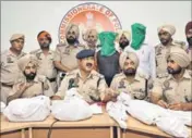  ??  ?? Police commission­er Arpit Skhula (centre) showing the arms and ammunition recovered in Jalandhar on Tuesday. PARDEEP PANDIT/HT